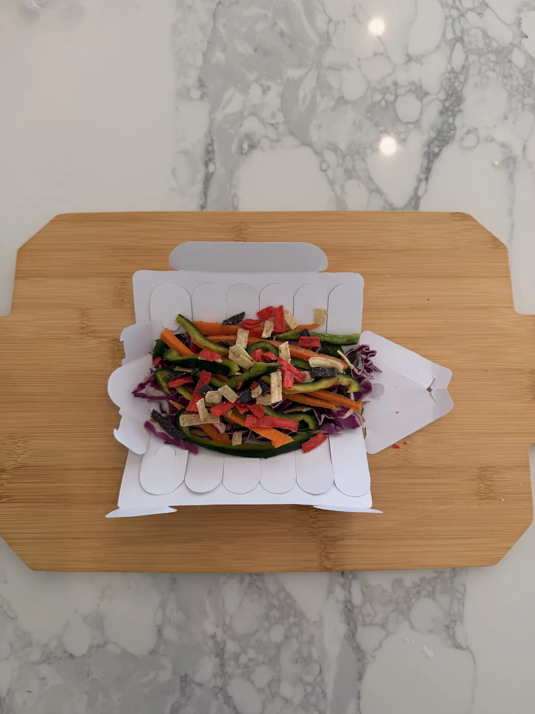 The tray opened flat with its scalloped sections and shredded vegetables